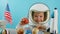 Smiling child holding a red planet Mars space rocket in his hands, close-up, pilot traveling into space. Child plays at