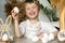 A smiling child holds white eggs and an Easter basket with rabbit ears in his hands, symbols of the Easter holiday