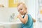 Smiling child kid boy brushing and clean teeth in bathroom himself