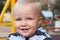 Smiling child outdoors in playground, portrait