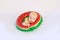 A smiling child in a swimsuit with a swimming ring in the shape of a watermelon lies on a white isolated background. Holidays at