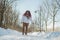 Smiling chubby redhead woman running in park in winter.