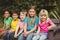 Smiling classmates sitting on bench