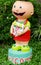 Smiling clay doll holding welcome signboard