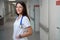 Smiling clinic employee in a bright hospital corridor