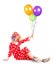 Smiling clown sitting and holding balloons