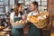 Smiling co-workers holding breads basket