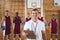 Smiling coach and basketball player standing in the court