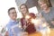 Smiling colleagues posing for businessman during rooftop party