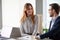 Smiling colleagues talk laughing during business meeting