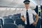 Smiling confident man in white shirt posing at the photo camera on the plane