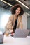 Smiling contented businesswoman closing laptop after finishing her work