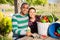 Smiling couple of amateur gardeners at table in garden