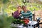 Smiling couple of amateur gardeners at table in garden