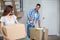 Smiling couple with cardboard box