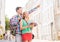 Smiling couple with city guide and backpack