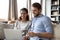 Smiling couple clients shopping online on laptop