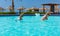 Smiling couple doing aqua fitness in swimming pool