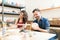 Smiling Couple Doing Creative Painting On Bowls In Pottery Works