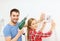 Smiling couple drilling hole in wall at home