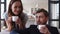 Smiling couple drinking tea at home together. Joyful couple taking coffee break