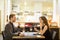 Smiling couple eating main course at restaurant