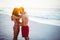 Smiling couple facing each other on the beach