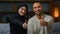 Smiling couple family african american man and arabian muslim woman diverse wife husband sitting on sofa together