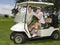 Smiling Couple In Golf Cart