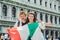 smiling couple holding italian flag venice central square san marco