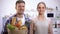 Smiling couple holding paper bag of groceries, healthy lifestyle, cooking