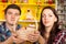 Smiling couple holding a wicker basket of cookies