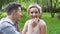 Smiling couple in love having fun at romantic picnic in summer park, slow-mo