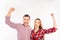 Smiling couple in love with raised hands
