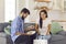 Smiling couple man and woman unpacking healthy boxed food order delivered to home by courier