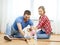 Smiling couple measuring wood flooring