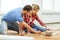 Smiling couple measuring wood flooring