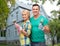 Smiling couple with paint brushes over house