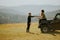 Smiling couple preparing hiking adventure with backpacks by terrain vehicle