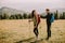 Smiling couple preparing hiking adventure with backpacks by terrain vehicle