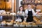 Smiling couple selling pastry and loaves