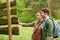 Smiling couple at signpost with backpacks hiking