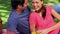 Smiling couple sitting on a blanket during a picnic