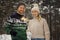 Smiling couple with sparklers outdoors in snowy winter forest. people with burning bengal lights