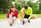 Smiling couple tying shoelaces outdoors