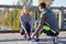 Smiling couple tying shoelaces outdoors