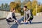 Smiling couple tying shoelaces outdoors