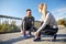 Smiling couple tying shoelaces outdoors