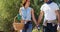 Smiling couple walking with wicker basket in farm 4k