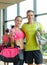 Smiling couple with water bottles in gym